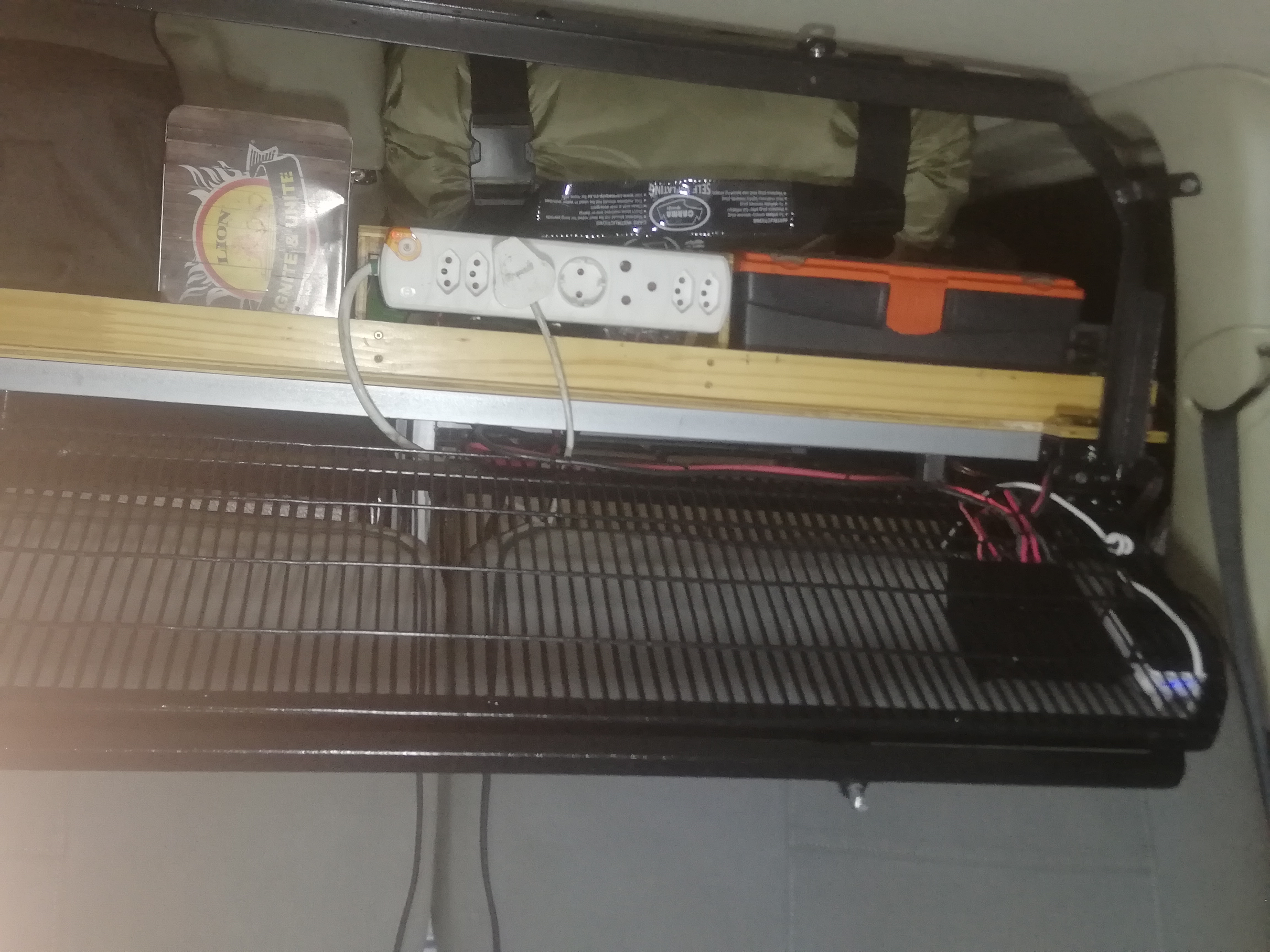 The grid can be opened to access the shelf from inside the vehicle