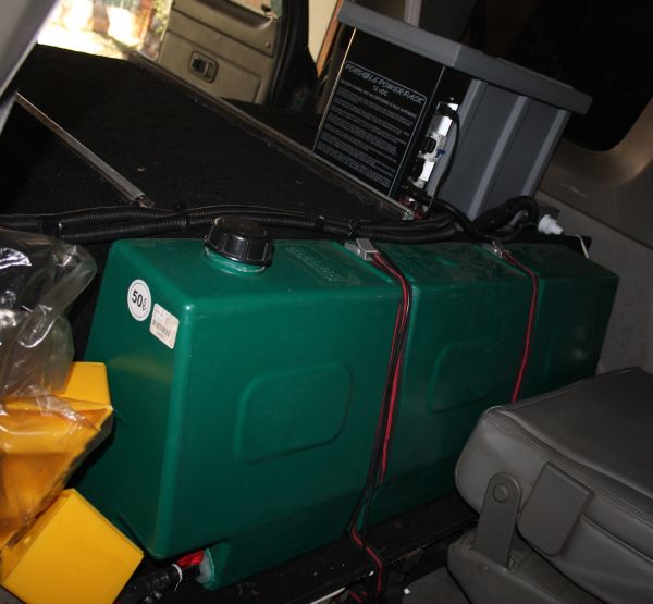 50 lt Pioneer Plastics water tank behind middel row seats. Front of tank slopes backwards to allow reclining of seats
