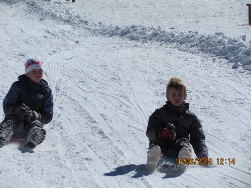 My boys ....kickin' up snow in their plastic bum board